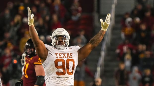 Texas Longhorns defensive lineman Byron Murphy II (90) celebrates sacking the Iowa State Cyclones quarterback during the game at Jack Trice Stadium.